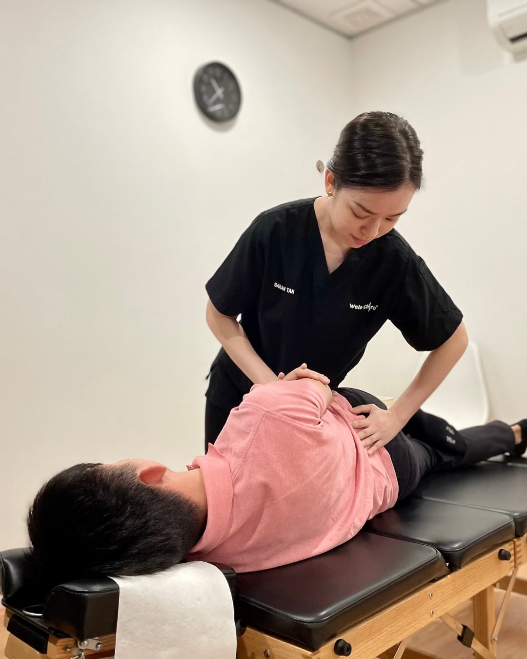A chiropractor performing a hands-on adjustment
