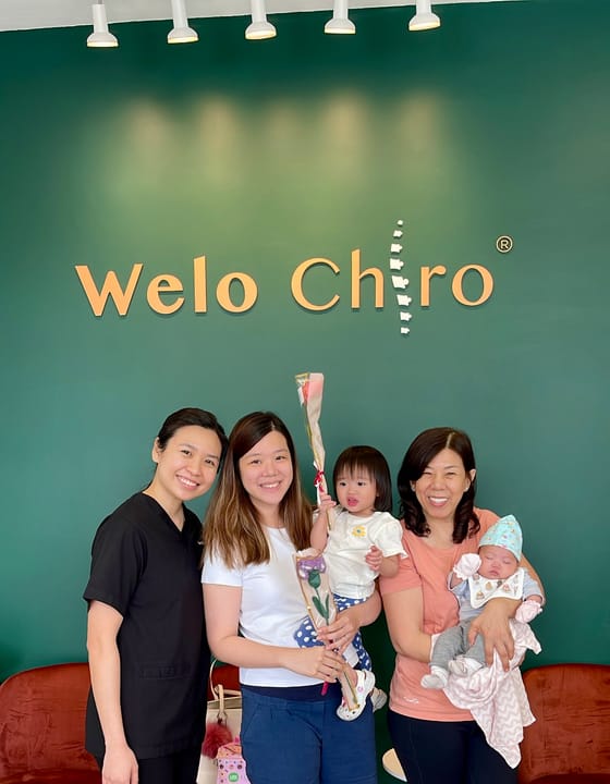 A Welo chiropractor with a family and their young children
