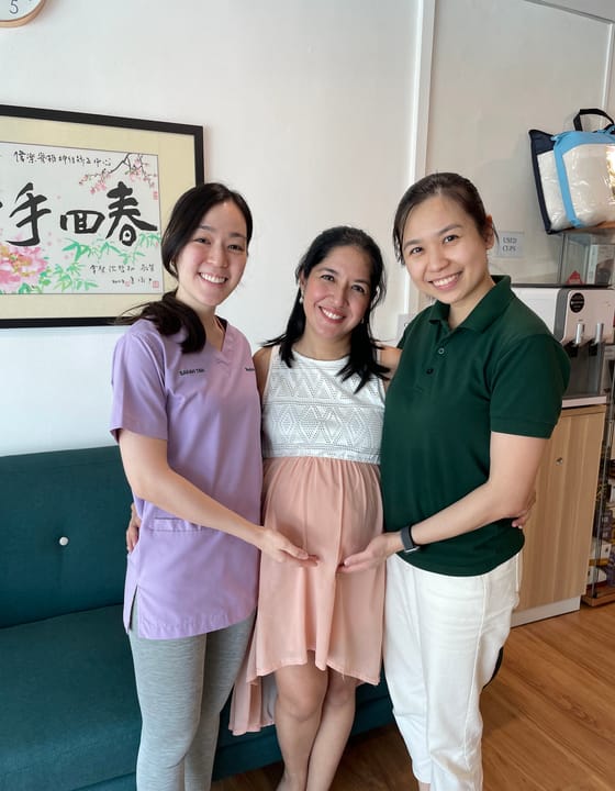 Two Welo chiropractors with an expectant mother after a session